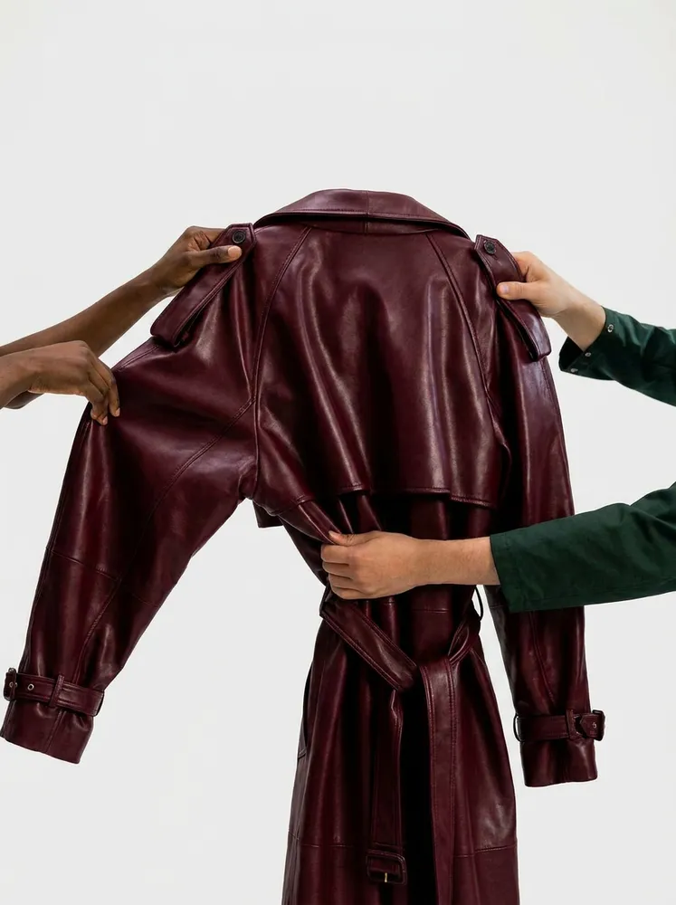Hands passing over a maroon leather coat during a Ragpiq handoff